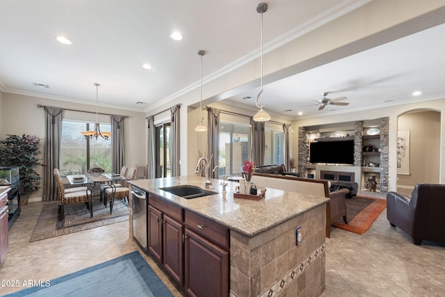 kitchen featuring a sink, dishwasher, an island with sink, plenty of natural light, and pendant lighting