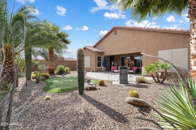 back of house with a patio, fence, and stucco siding