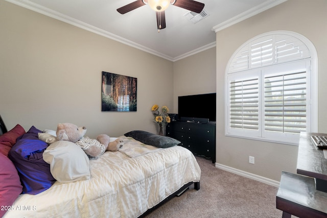 carpeted bedroom with baseboards, a ceiling fan, visible vents, and crown molding