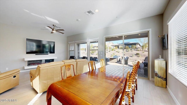 dining space with ceiling fan and light wood-type flooring