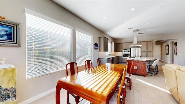 dining space with sink and light hardwood / wood-style flooring