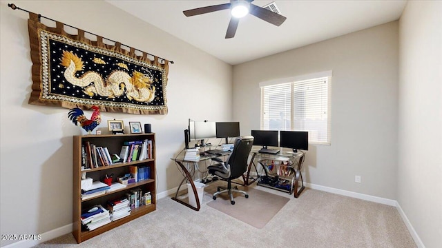 carpeted office space with ceiling fan