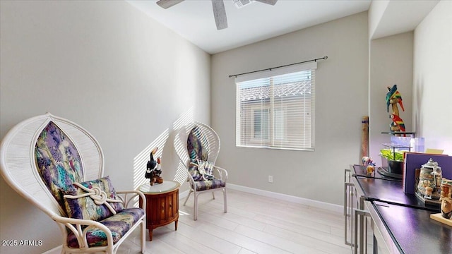 living area with ceiling fan and light wood-type flooring