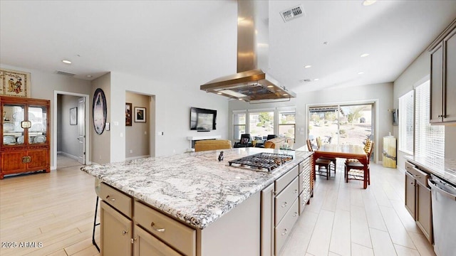 kitchen featuring a breakfast bar, appliances with stainless steel finishes, island exhaust hood, light stone countertops, and a kitchen island