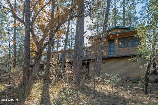 rear view of house featuring a wooden deck