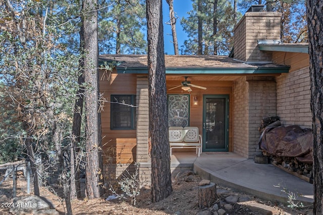 view of exterior entry with ceiling fan