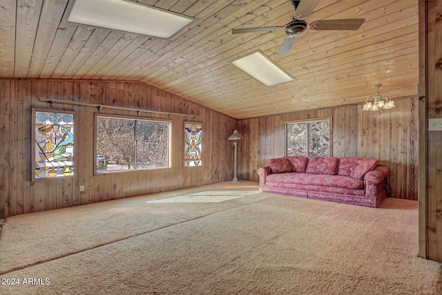 unfurnished living room featuring wood ceiling, plenty of natural light, and wood walls