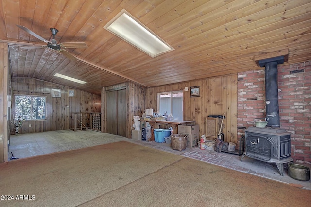 misc room featuring a wood stove and wooden ceiling