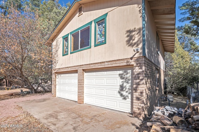 view of side of home featuring a garage