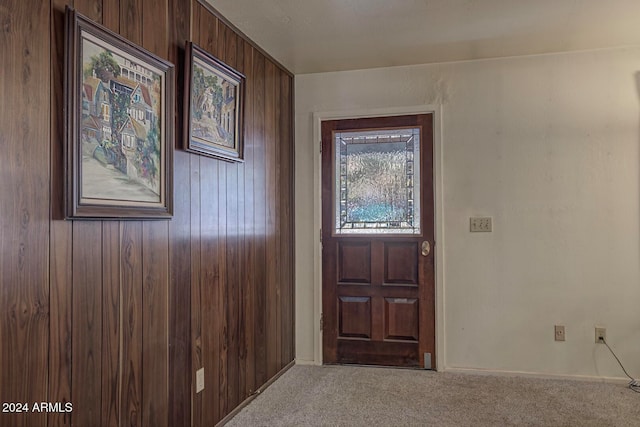 entryway with wooden walls and carpet