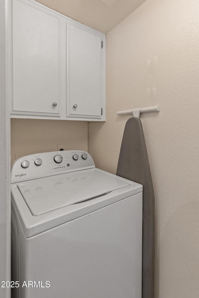 washroom with cabinet space and washer / clothes dryer