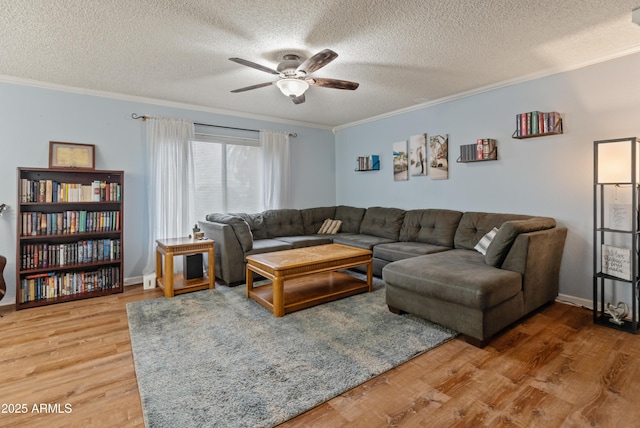 living room with wood finished floors, ceiling fan, and crown molding