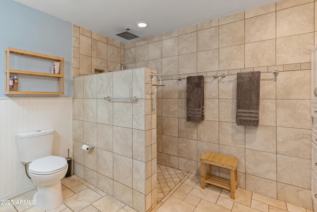 full bath with tile patterned flooring, toilet, and walk in shower