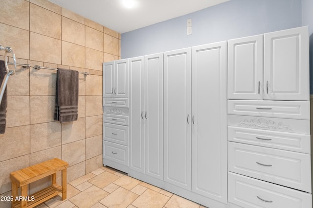 bathroom featuring tile walls