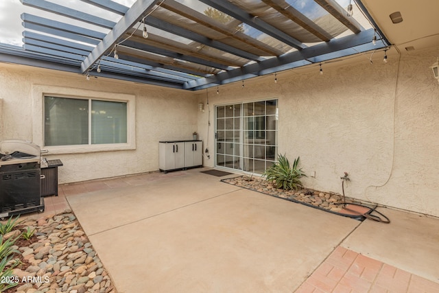 view of patio / terrace with area for grilling and a pergola