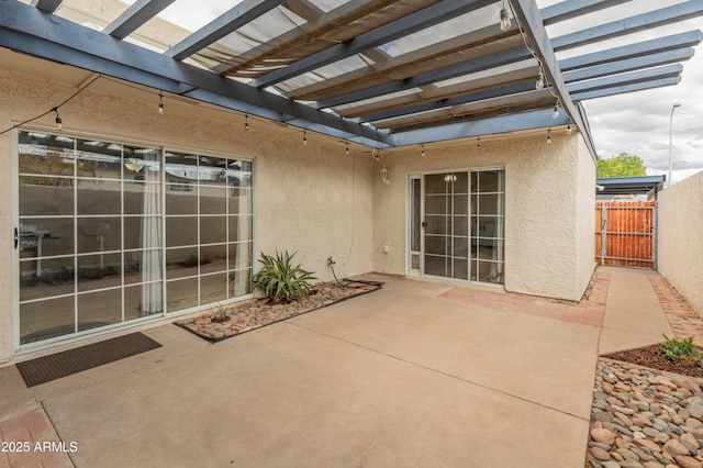 view of patio / terrace with a pergola and fence