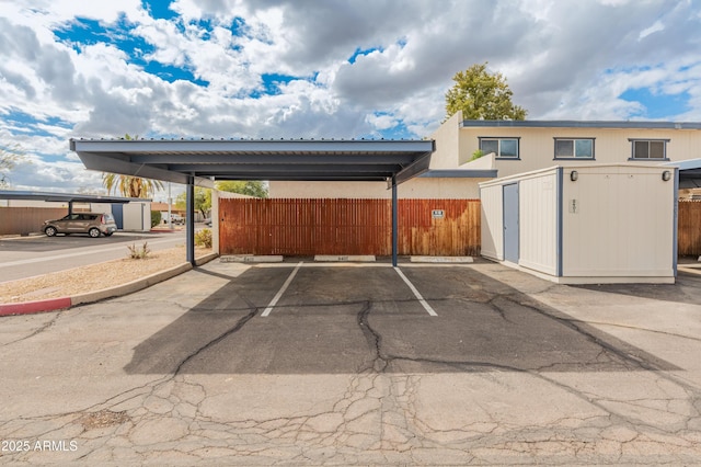 partially covered parking lot with fence