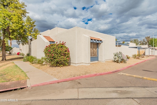 view of front of property with stucco siding and a tile roof