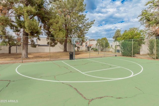 view of basketball court with community basketball court and fence