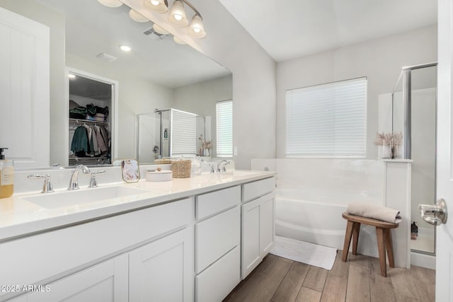 11526 E Shepperd Ave, Mesa, AZ 85212 - bathroom with a stall shower, a bath, wood finished floors, a spacious closet, and double vanity