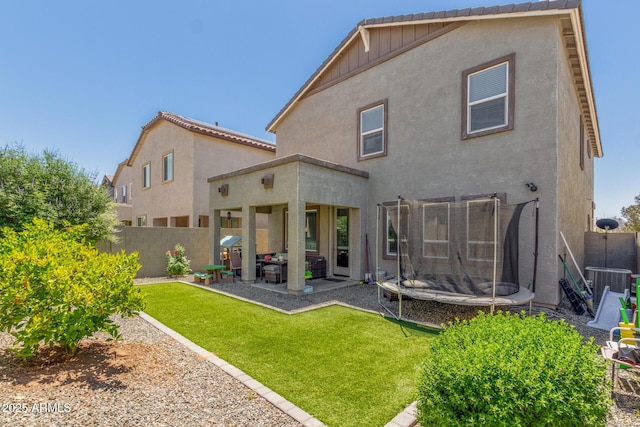 11526 E Shepperd Ave, Mesa, AZ 85212 - back of house featuring a trampoline, stucco siding, a patio, and board and batten siding