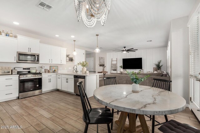 11526 E Shepperd Ave, Mesa, AZ 85212 - dining room with light wood finished floors, recessed lighting, ceiling fan, and a chandelier