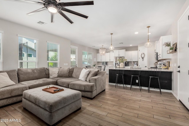 11526 E Shepperd Ave, Mesa, AZ 85212 - living area with light wood-style floors, plenty of natural light, a ceiling fan, and recessed lighting