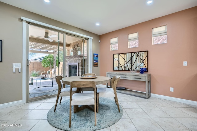 dining space with recessed lighting, a fireplace, and baseboards