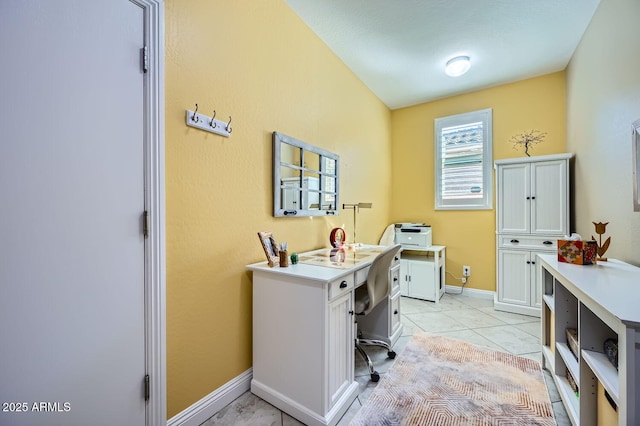 home office featuring light tile patterned floors and baseboards