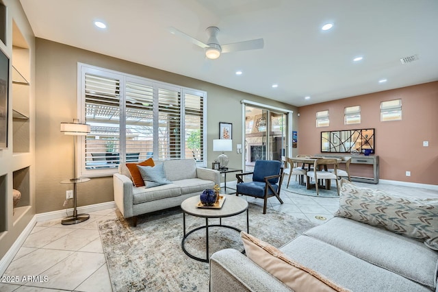 living area featuring light tile patterned floors, visible vents, and recessed lighting