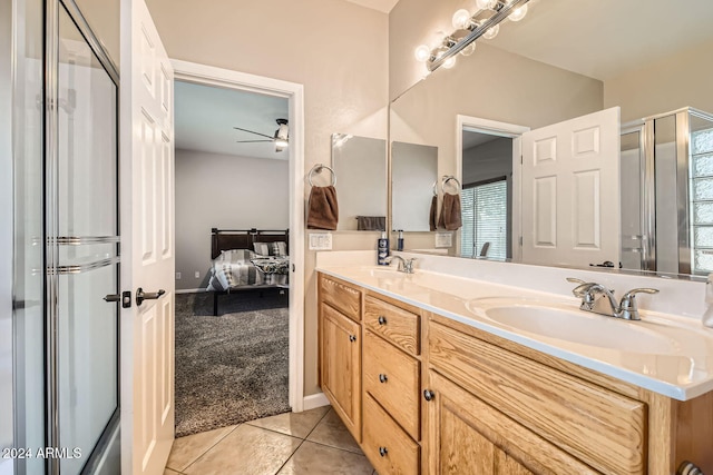 bathroom featuring tile patterned flooring, vanity, a healthy amount of sunlight, and ceiling fan