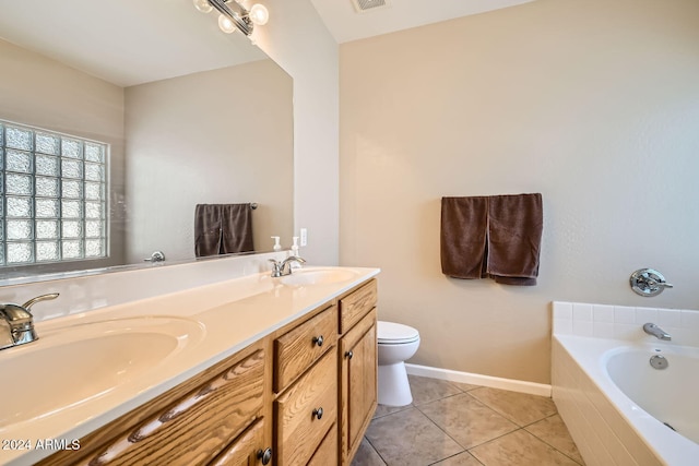 bathroom with toilet, vanity, tiled bath, and tile patterned flooring