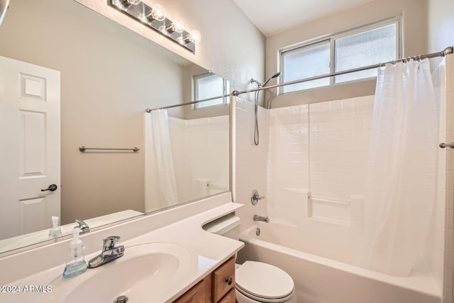 full bathroom with shower / bath combo, vanity, and toilet