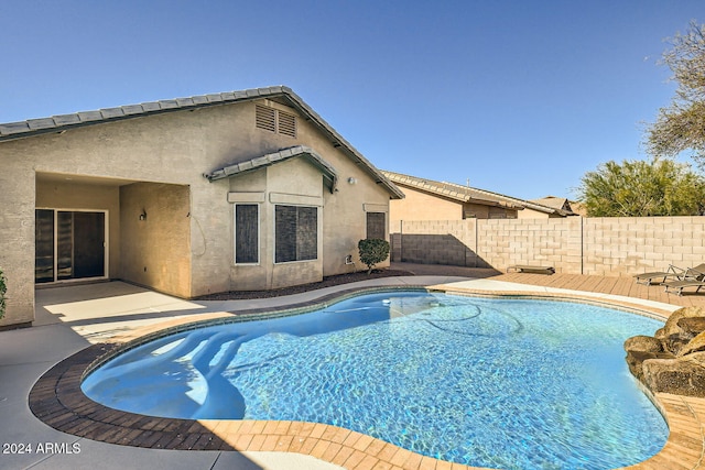 view of swimming pool with a patio