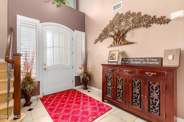 entrance foyer with baseboards, visible vents, and tile patterned floors