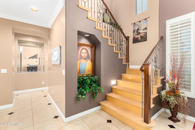 interior space featuring stairway, crown molding, visible vents, and light wood-style floors