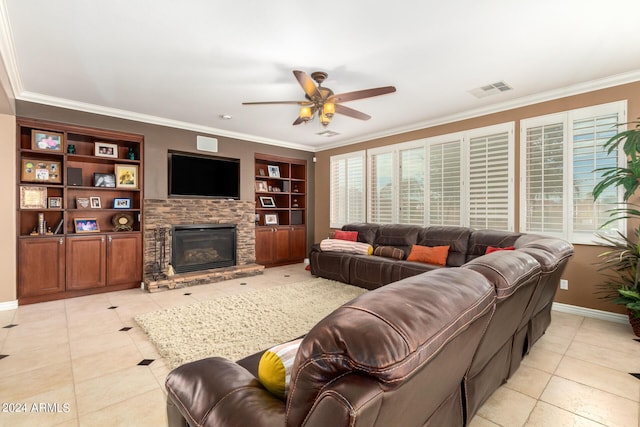 living area featuring built in features, visible vents, crown molding, a stone fireplace, and light tile patterned flooring