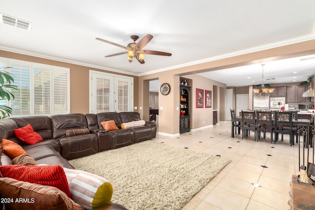 dining area with ceiling fan with notable chandelier, baseboards, crown molding, and light tile patterned flooring