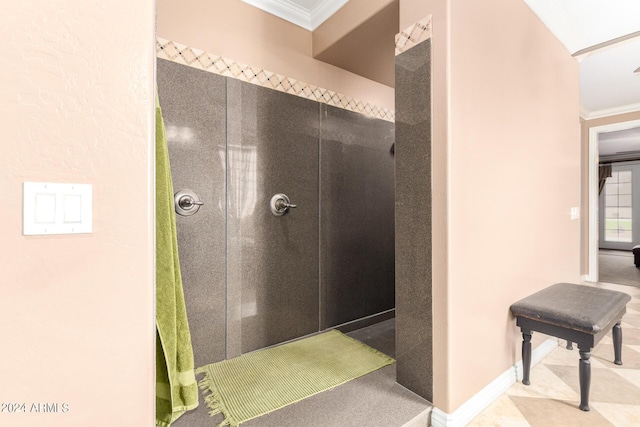 bathroom featuring baseboards, a shower stall, and crown molding