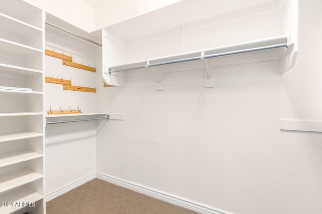 bedroom featuring visible vents, wainscoting, ceiling fan, carpet, and crown molding