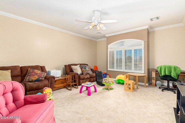 rec room with baseboards, visible vents, ceiling fan, carpet, and crown molding