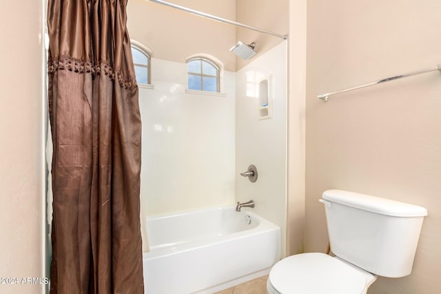 full bath featuring shower / bath combo, toilet, and tile patterned floors