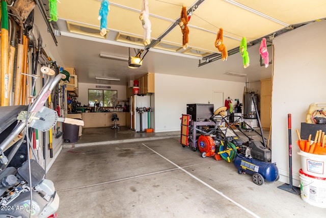 garage featuring water heater and a garage door opener