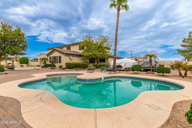 view of pool with a patio area, fence, and a fenced in pool