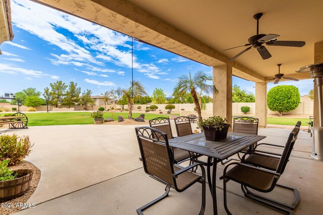 view of patio / terrace with outdoor dining space, a fenced backyard, and a ceiling fan