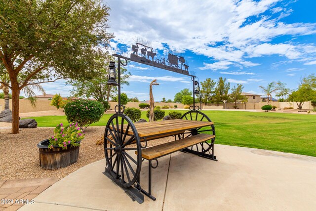 view of home's community with outdoor dining area, a patio area, and a yard