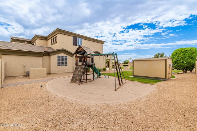 view of play area featuring an outbuilding and a storage unit