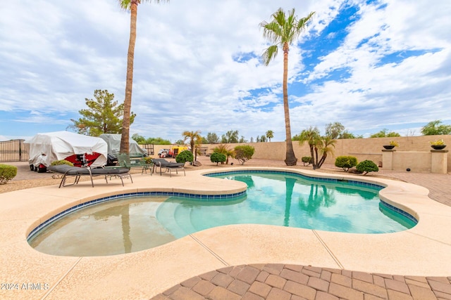 view of swimming pool featuring a fenced backyard, a fenced in pool, and a patio