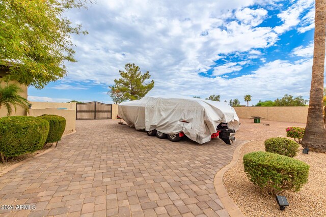 view of patio featuring exterior kitchen, outdoor dining space, an outdoor stone fireplace, and a fenced backyard