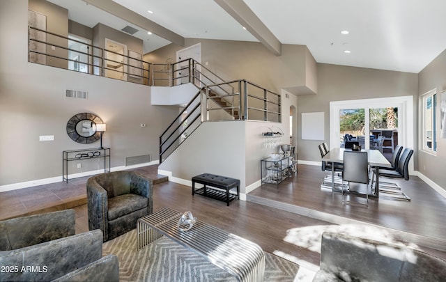 living room featuring dark wood-type flooring and a high ceiling